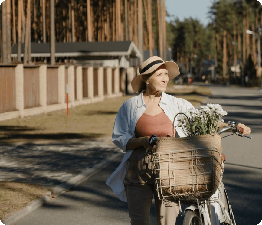 A woman walking her bicycle.