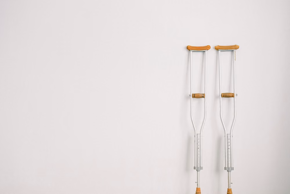 A set of crutches leaning against a wall.