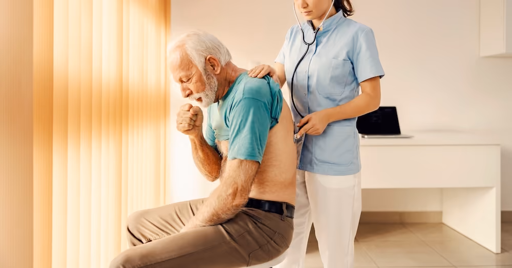 A man coughing as he is being examined by a medical professional
