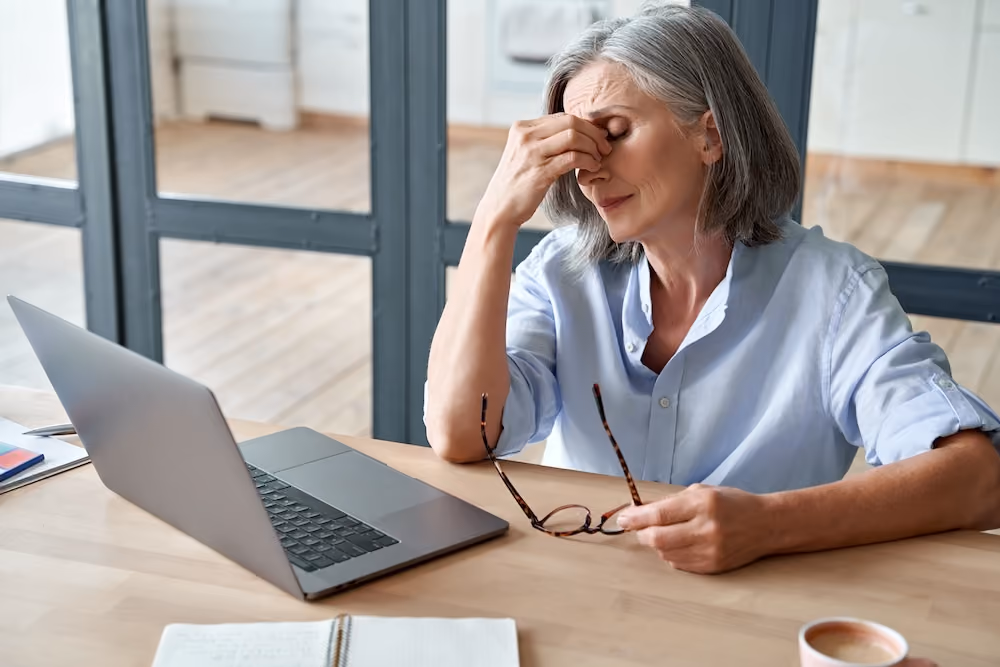 A tired woman at the computer