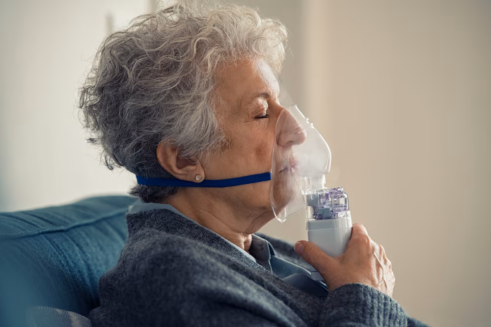 A senior woman using a COPD inhaler