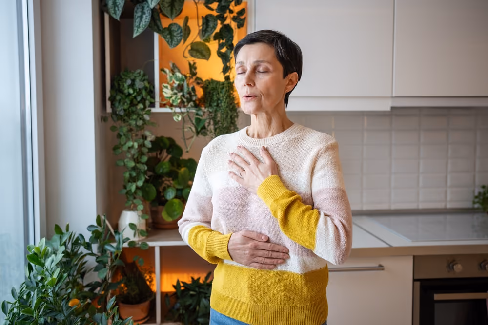 a senior woman breathing clean air indoors