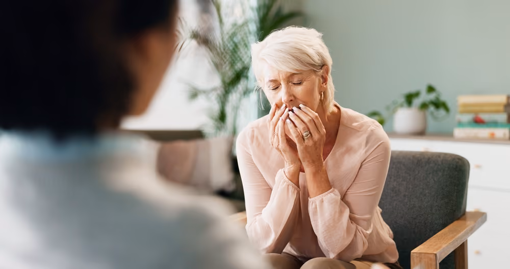 A senior woman talking to a therapist.