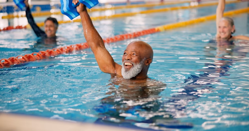 A senior man performing water aerobics
