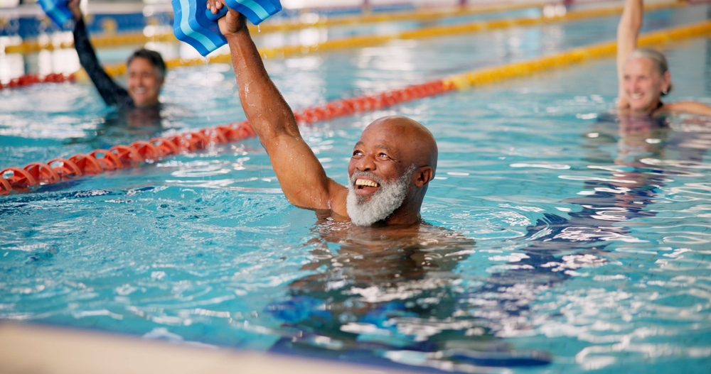 A senior man performing water aerobics