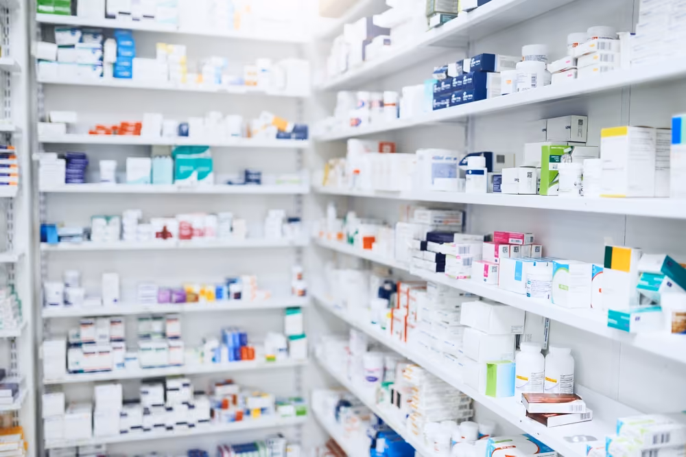 A pharmacy's shelves, filled with prescription drugs.