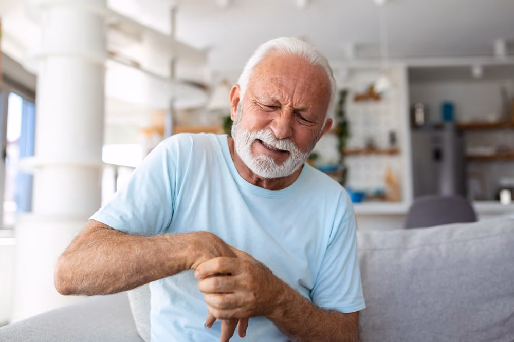 A man visibly suffering from arthritic pain.