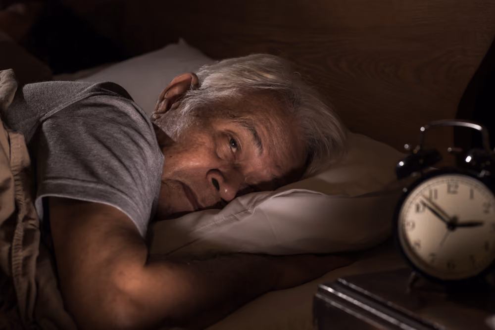 An older man suffering from insomnia.