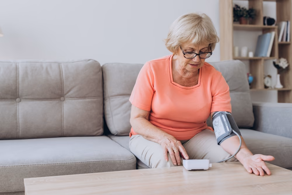 A senior woman measuring her blood pressure