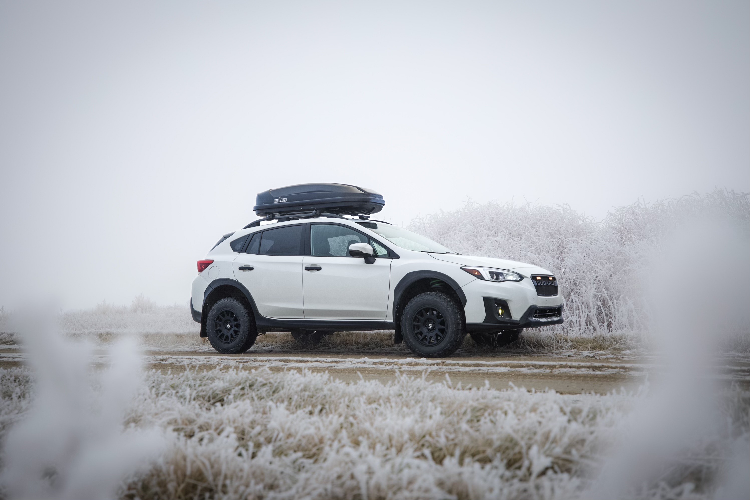 Lifted off-road Subaru Crosstrek with cargo box on the roof