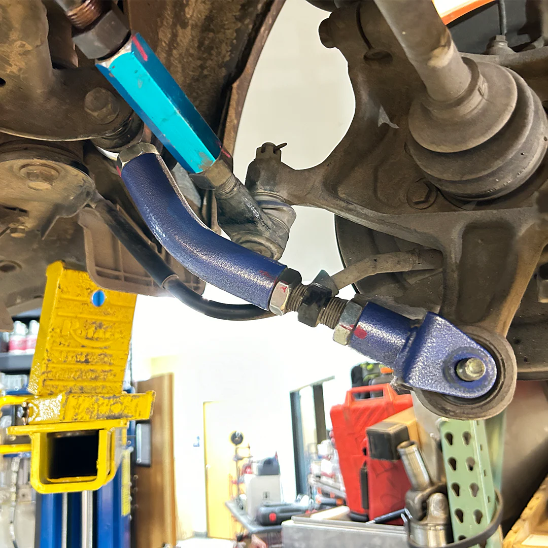 Off road trailing arms installed on a lifted Subaru Forester