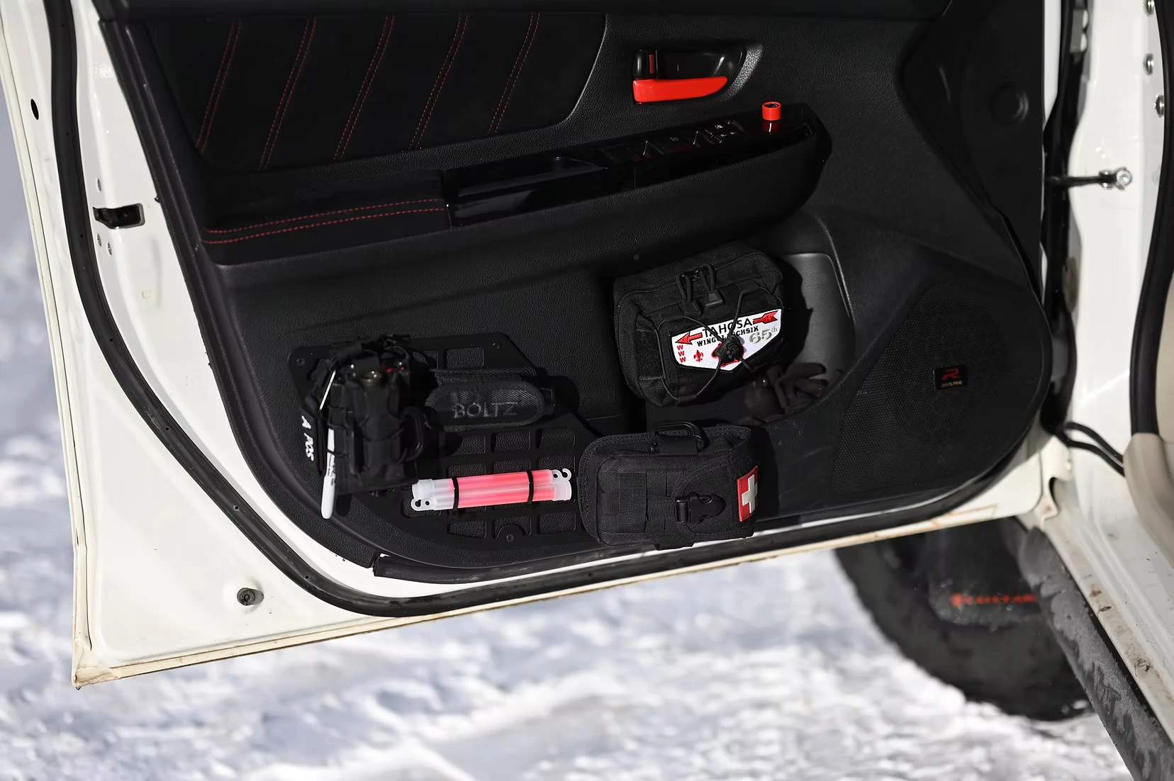 Overland Subaru with front door Molle panel holding a radio and other accessories