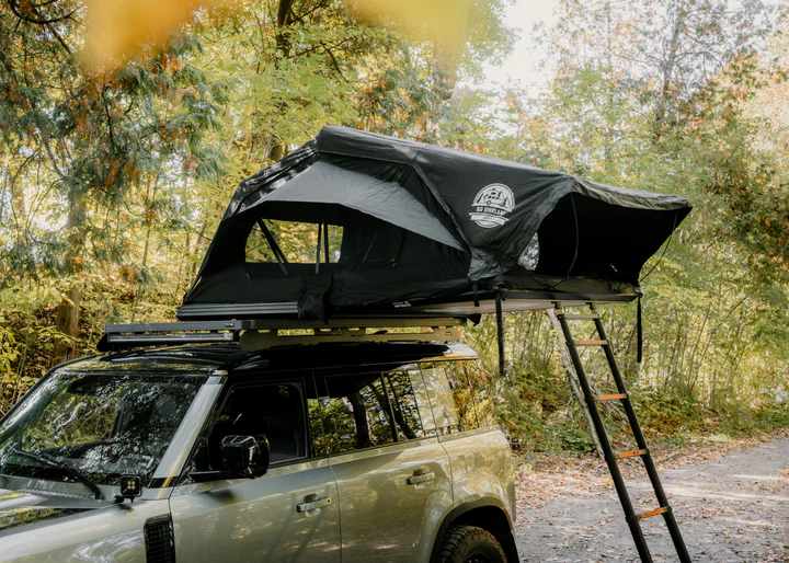 Hybrid folding roof top tent on lifted overland vehicle