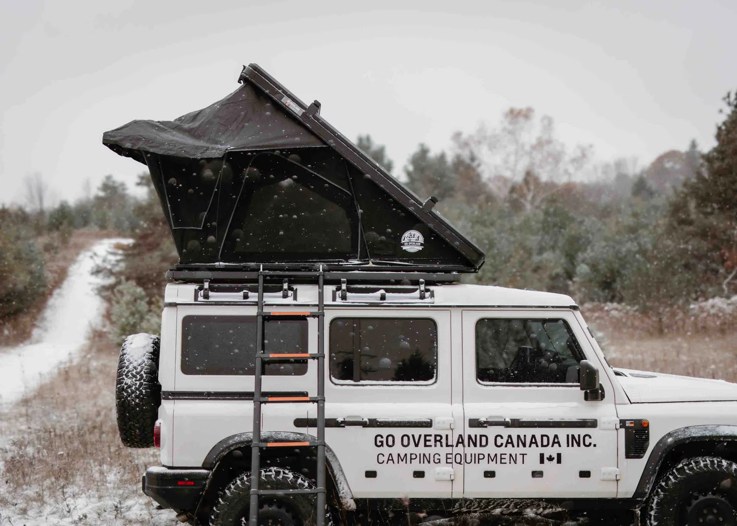 Clam shell hard shell roof top tent on lifted overland vehicle
