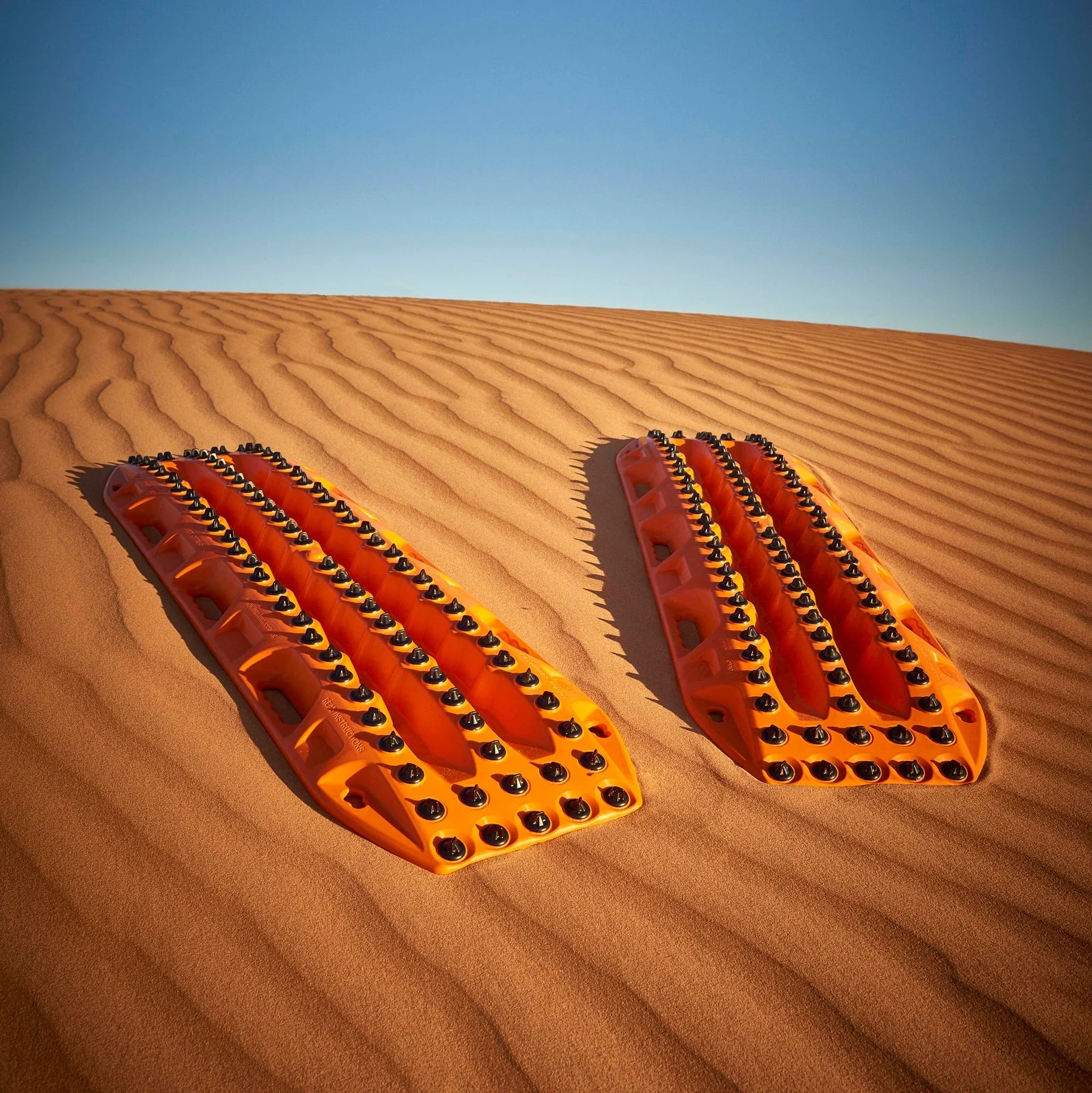 Extreme traction boards used to recovery stuck off road vehicle in sand 