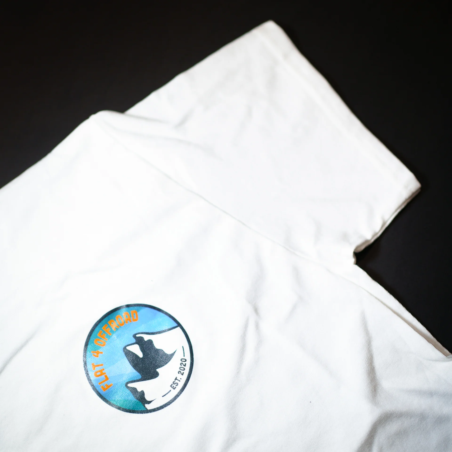 White t-shirt with colour Flat 4 Offroad logo on corner