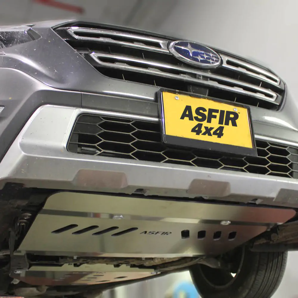 Thick aluminum skid plate protecting the engine of the Subaru Outback
