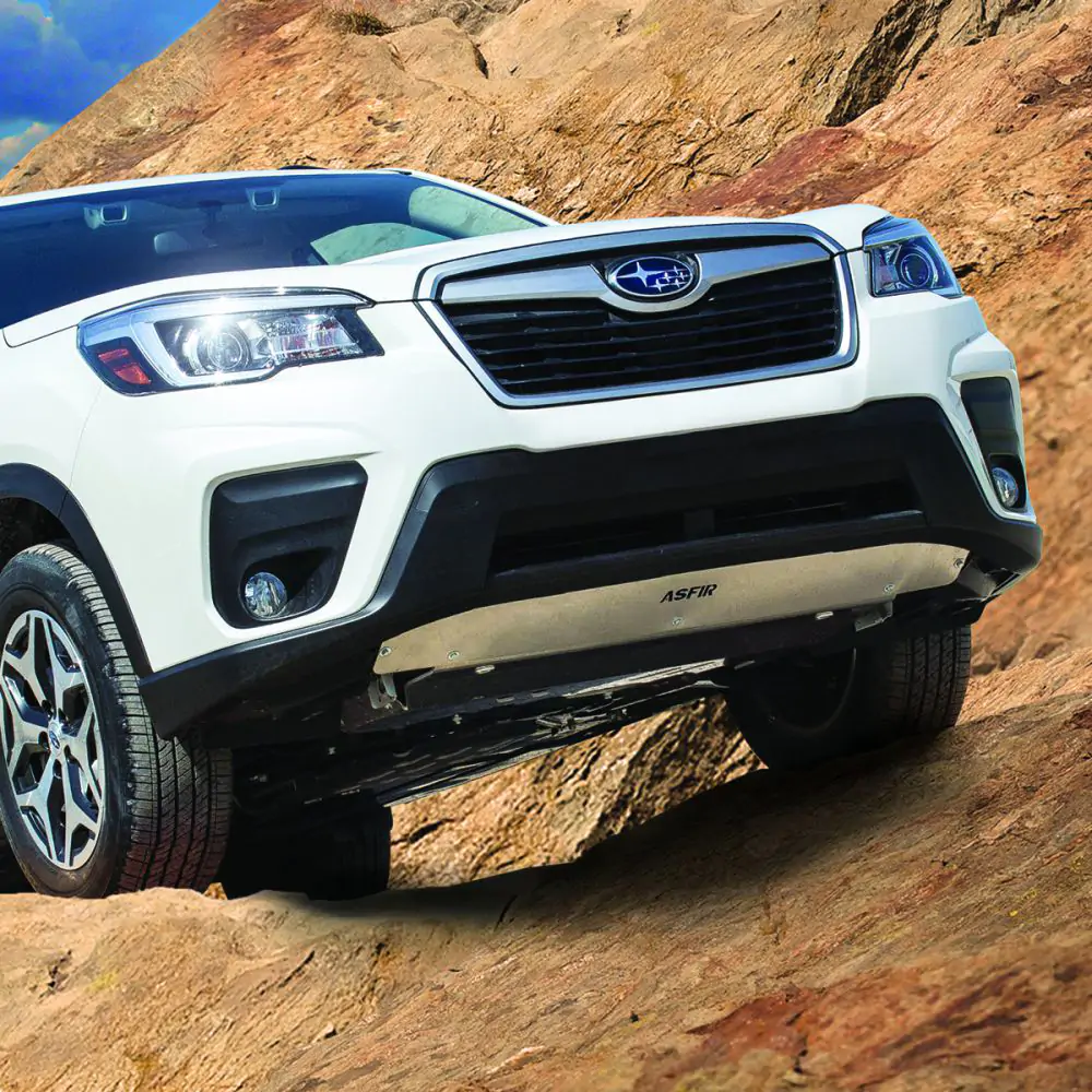 Thick aluminum skid plate protecting the engine of the Subaru Forester