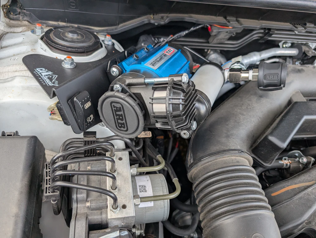 CAtuned Off-Road ARB CKMA12 brushless compressor kit with CNC steel mount installed in a Subaru Crosstrek engine bay