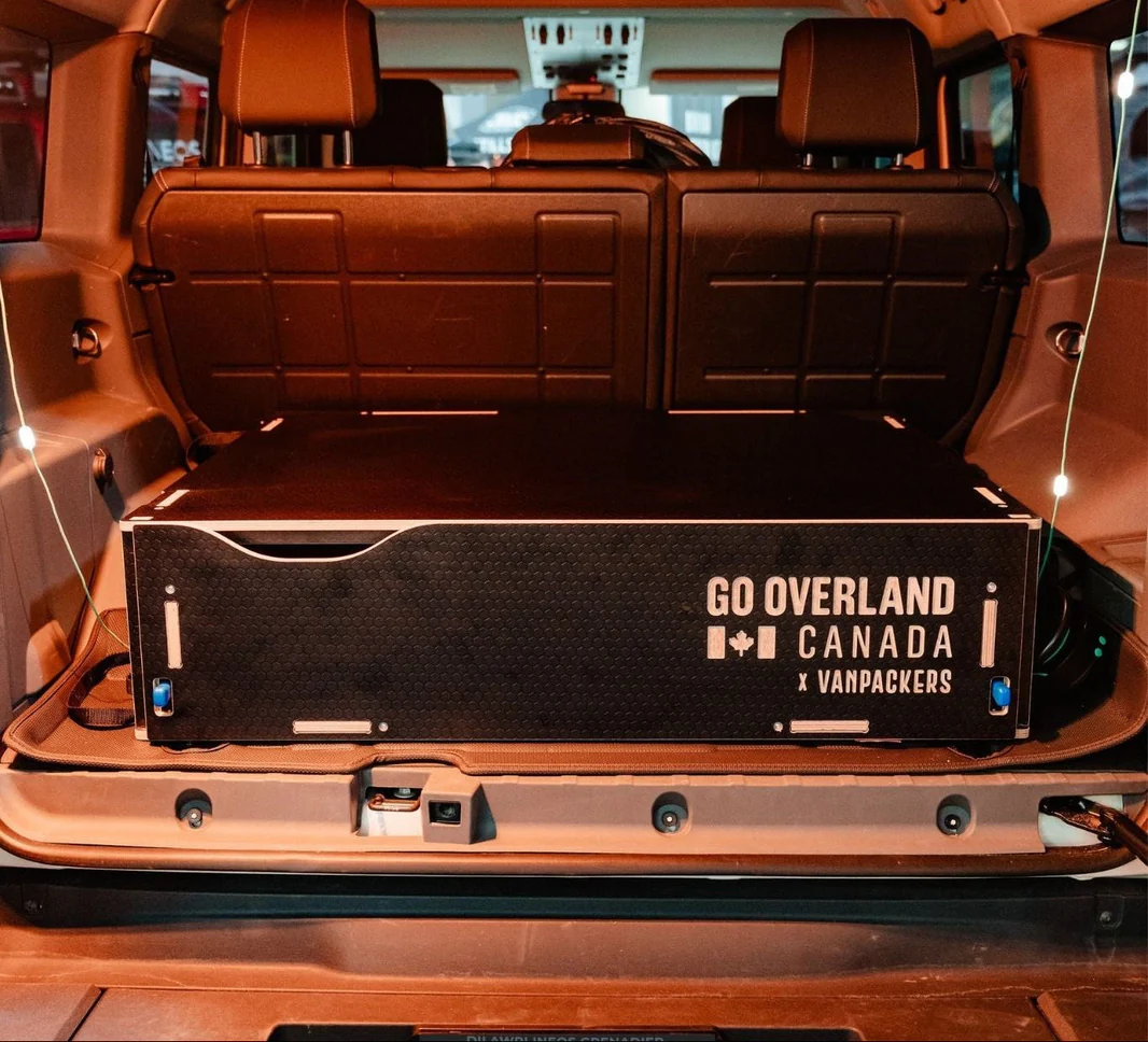 Go Overland TrailBox SUV drawer system open in vehicle trunk showing modular storage compartments