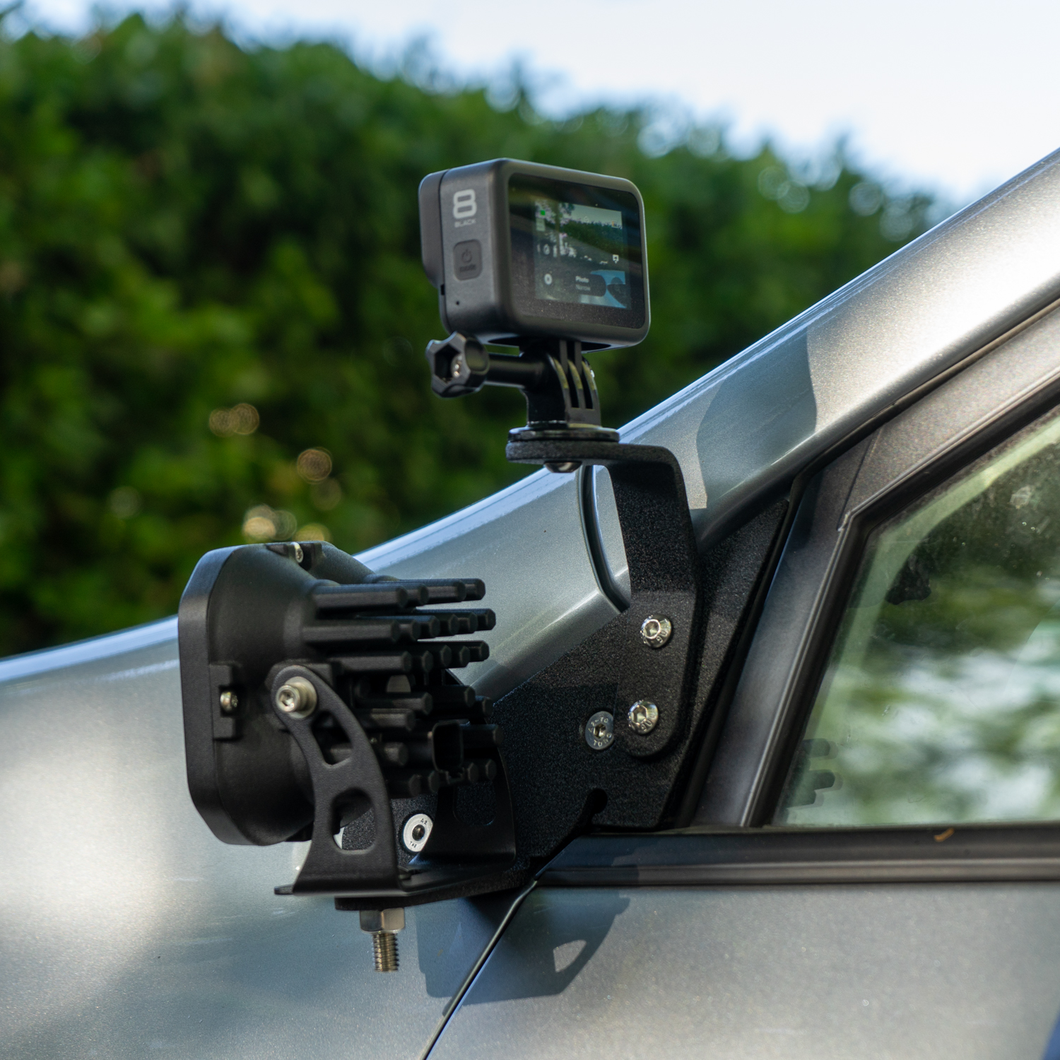 SMK Fabrication ditch light bracket installed on Subaru Forester hood hinge