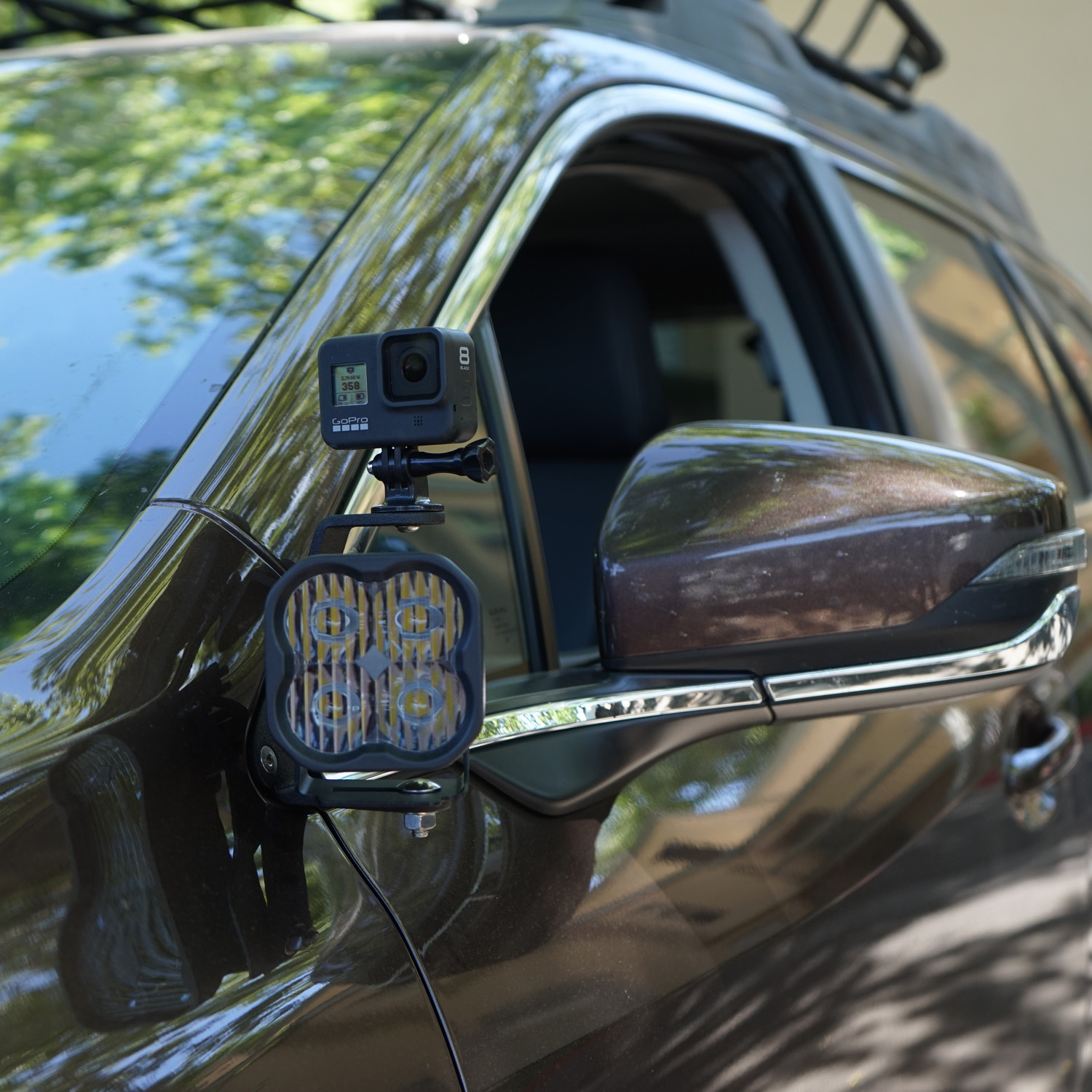 SMK Fabrication ditch light bracket installed on Subaru Outback hood hinge