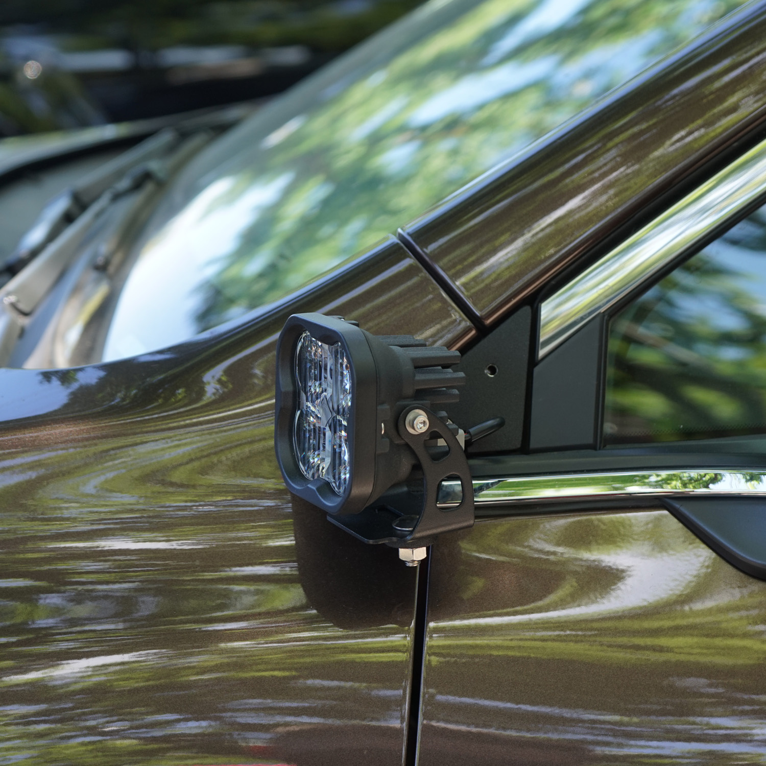 SMK Fabrication ditch light bracket installed on Subaru Outback hood hinge