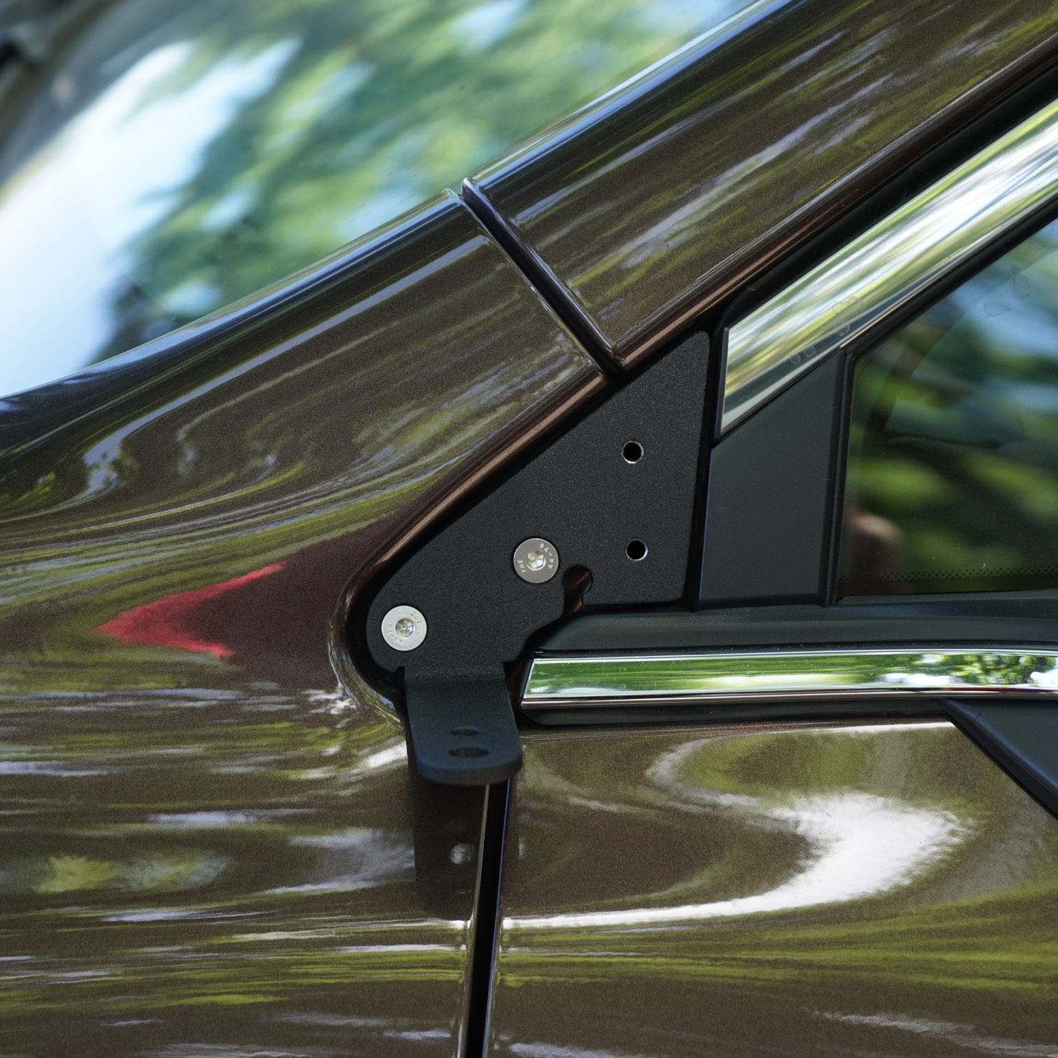 SMK Fabrication ditch light bracket installed on Subaru Outback hood hinge