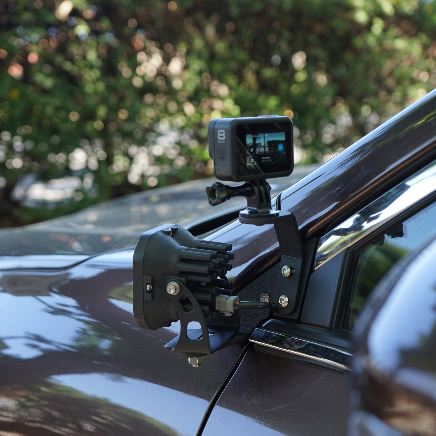 SMK Fabrication ditch light bracket installed on Subaru Outback hood hinge