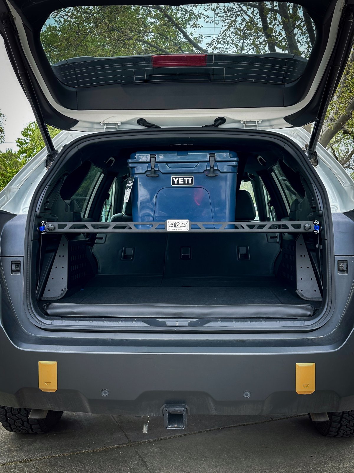 CAtuned Off-Road Platinum Cargo Shelf in black powder coat installed in a Subaru Outback cargo area with a cooler on top