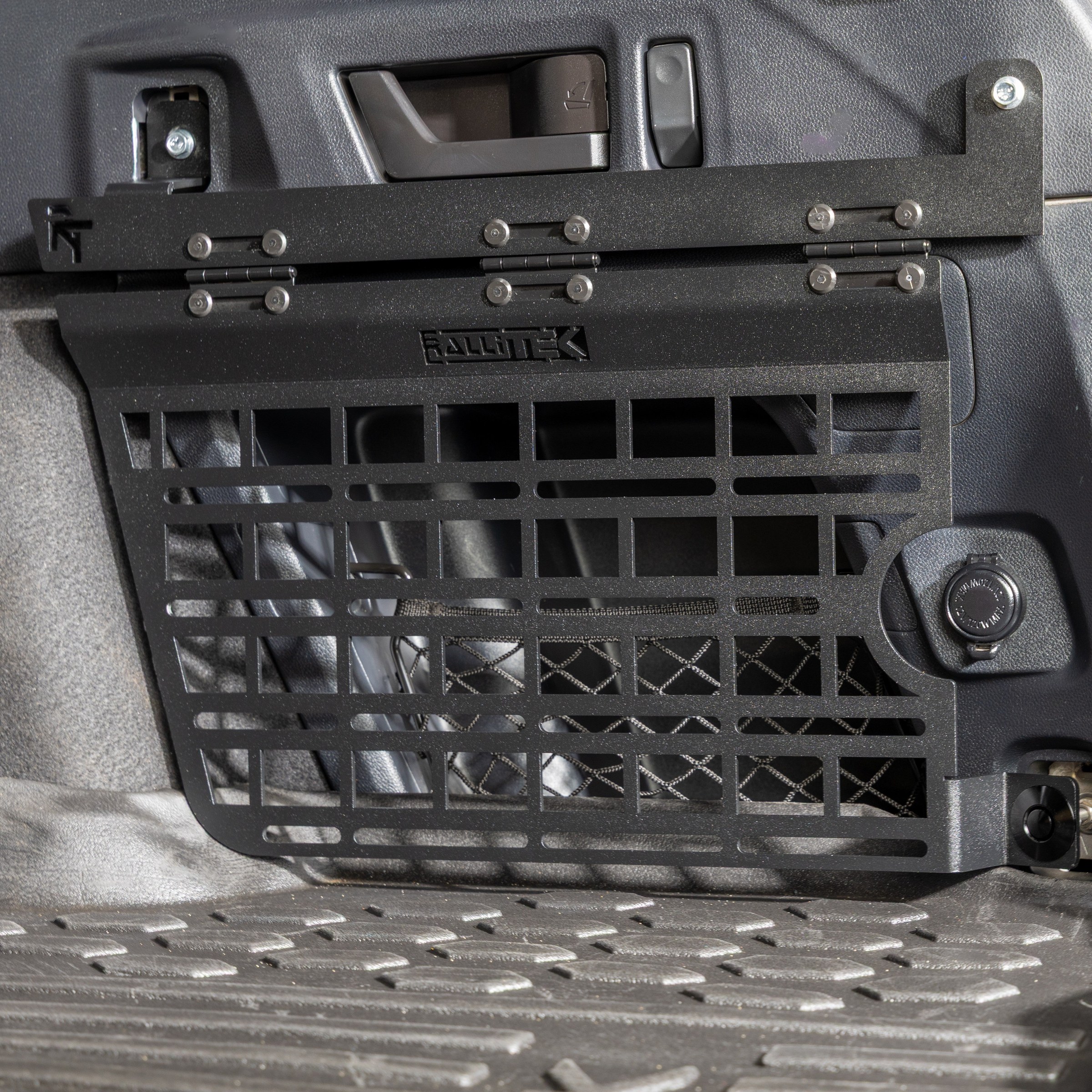RalliTEK rear cargo MOLLE panel installed on the passenger side wall of a Subaru Outback cargo area