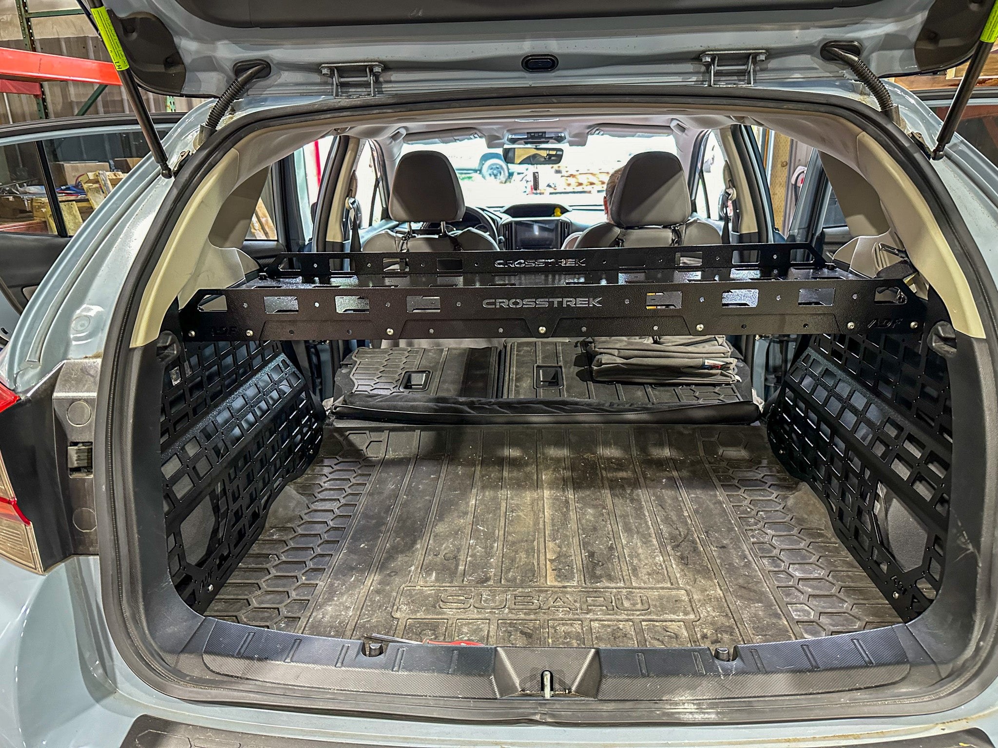 ADF Molle Shelf mounted between Molle racks in a Subaru Crosstrek cargo area