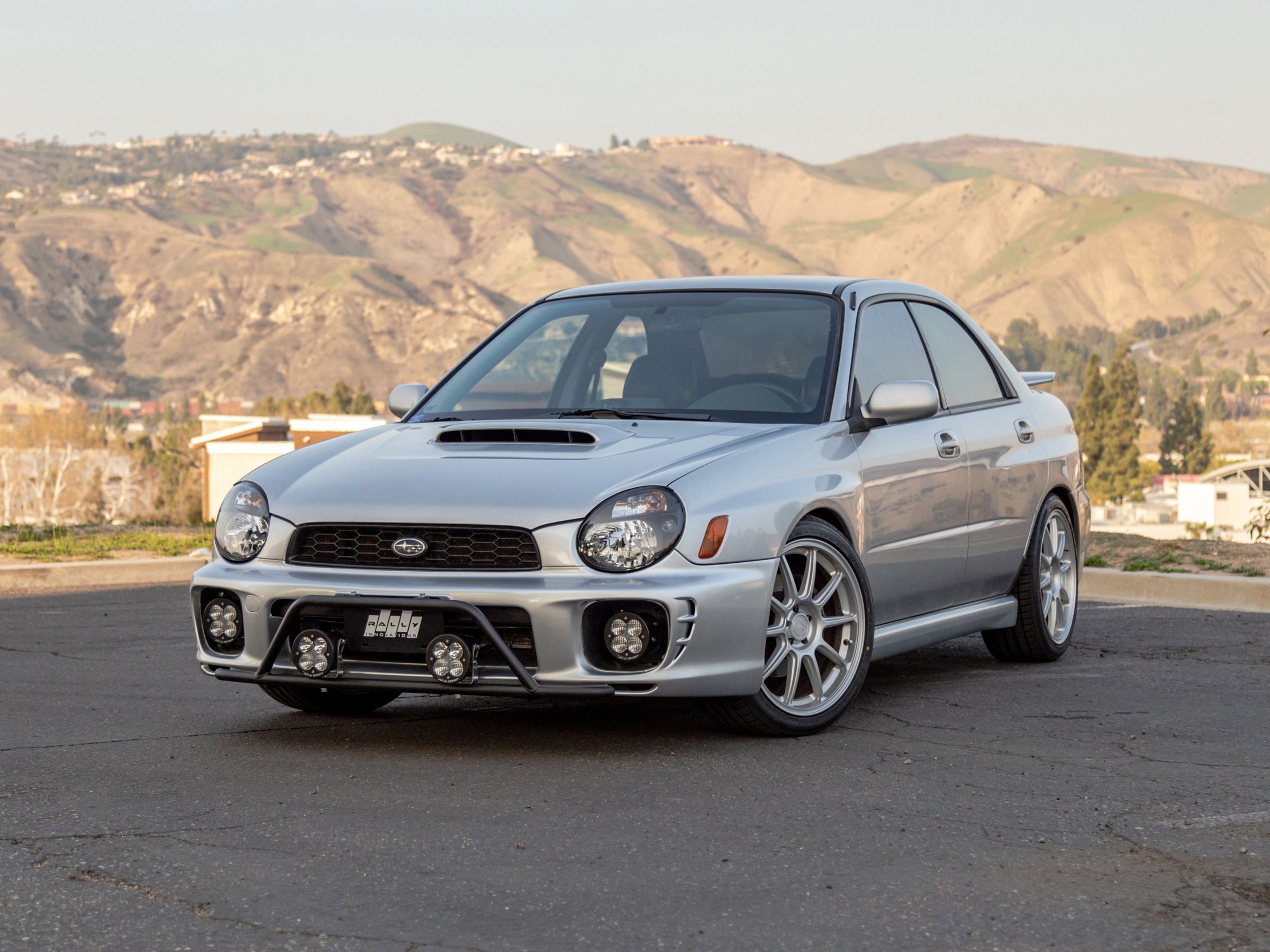Subaru WRX with a Rally Innovations Rally Light Bar and LED driving lights below the grille