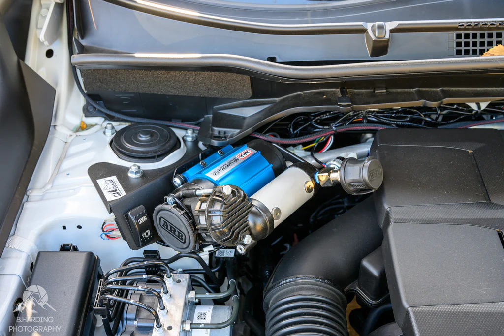 CAtuned Off-Road ARB CKMA12 brushless compressor kit with CNC steel mount installed in a Subaru Forester engine bay