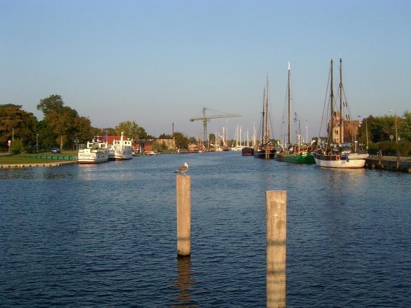Museumshafen Greifswald am Ryck mit historischen Segelschiffen und Dalben im Wasser