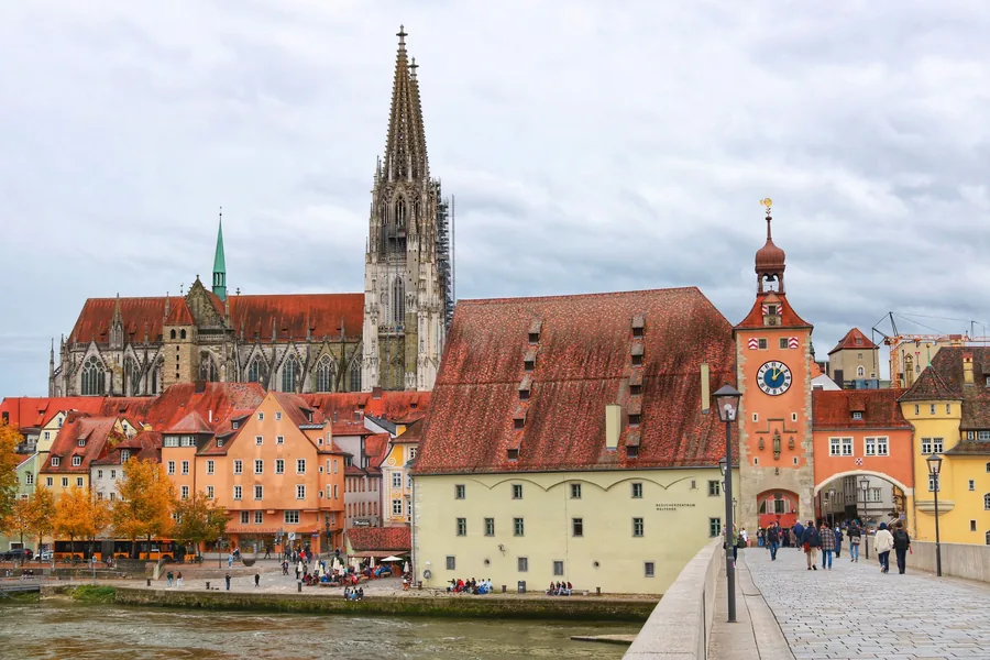Regensburger Altstadt an der Donau mit Dom, Salzstadel und Brückturm, Menschen auf der Steinernen Brücke