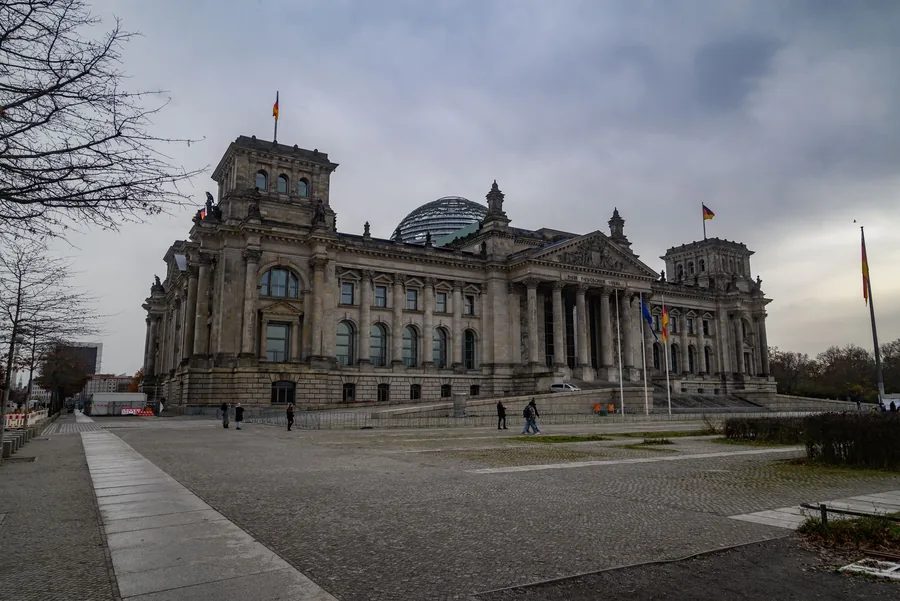 Reichstagsgebäude in Berlin mit Glaskuppel unter bewölktem Himmel