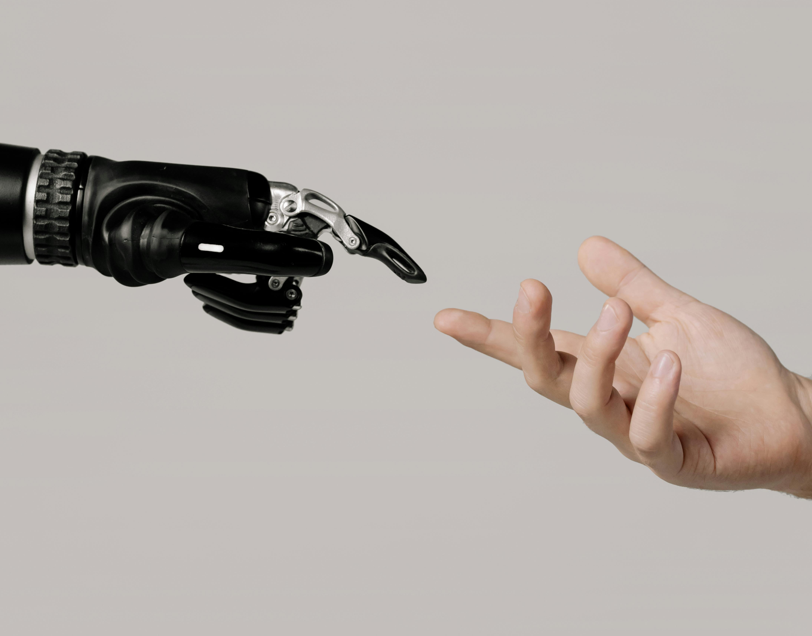 robotic hand touching human hand