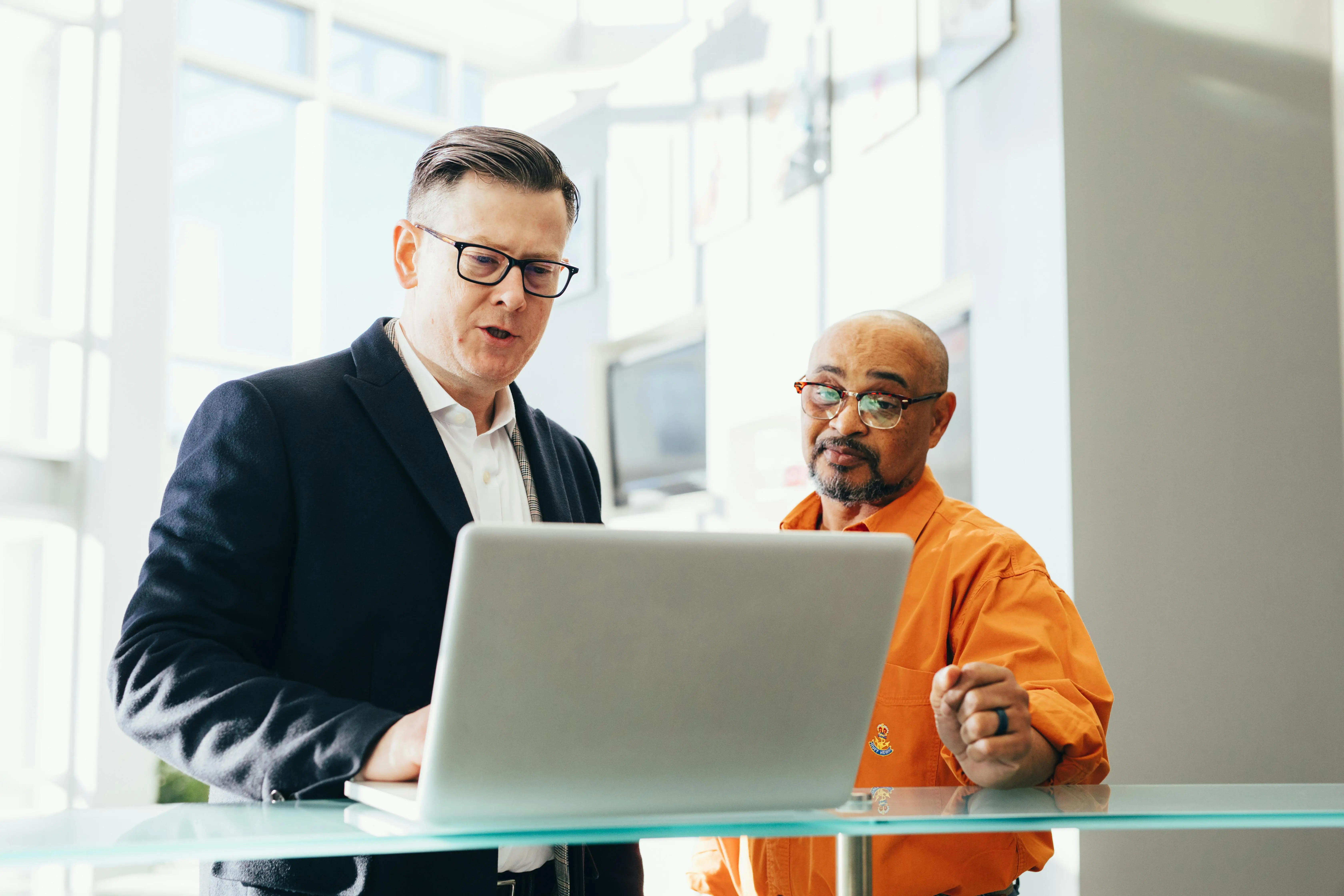 salespeople reviewing the latop