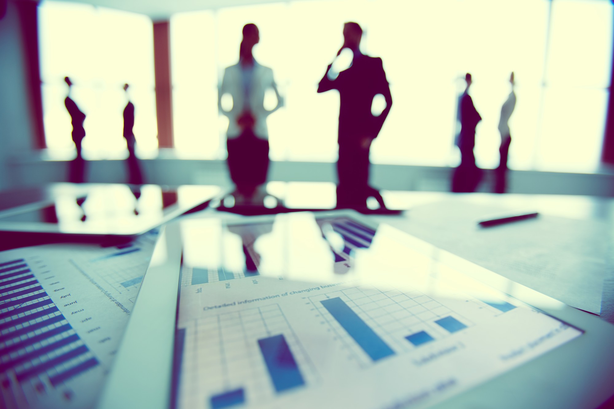 charts on a table with people in background