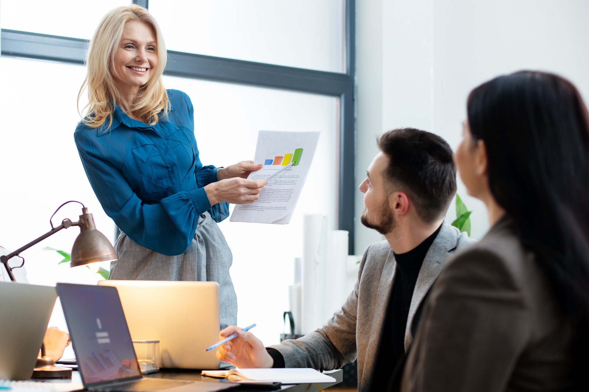 lady pointing at benchmarks on paper
