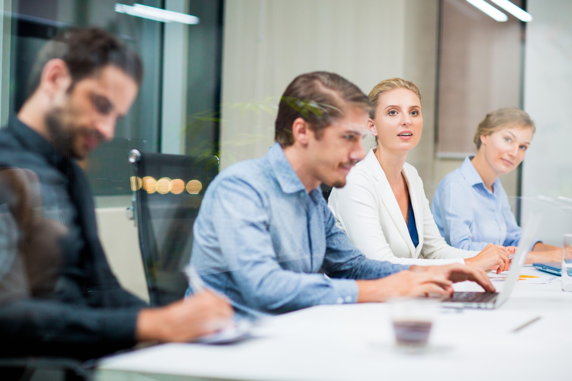 employees in meeting on laptop