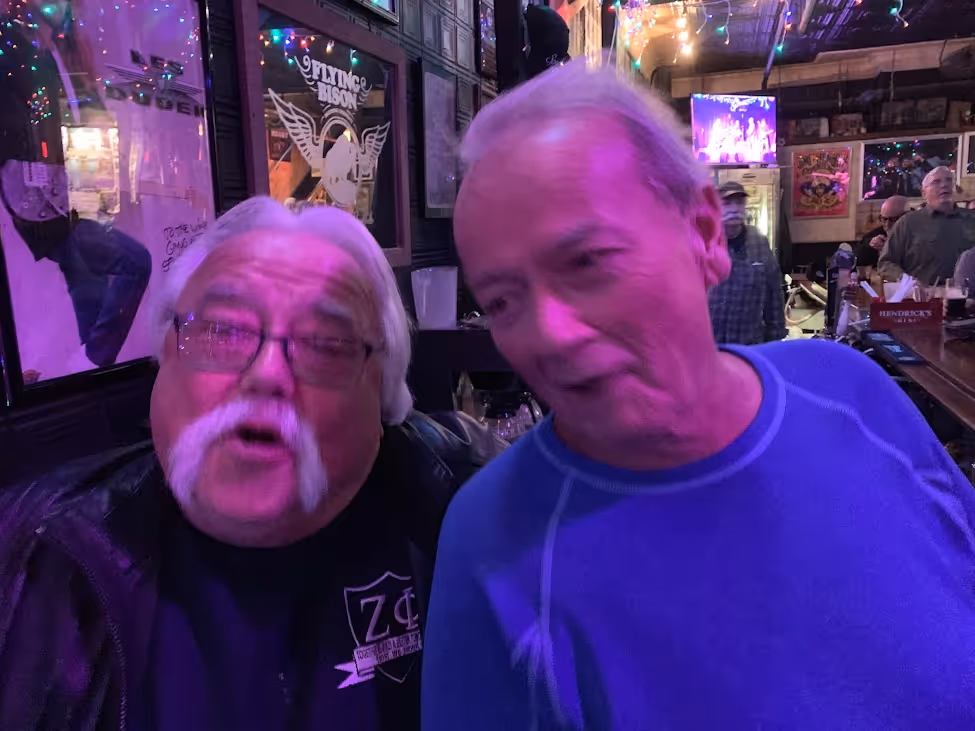 Two gentleman sitting in the bar.