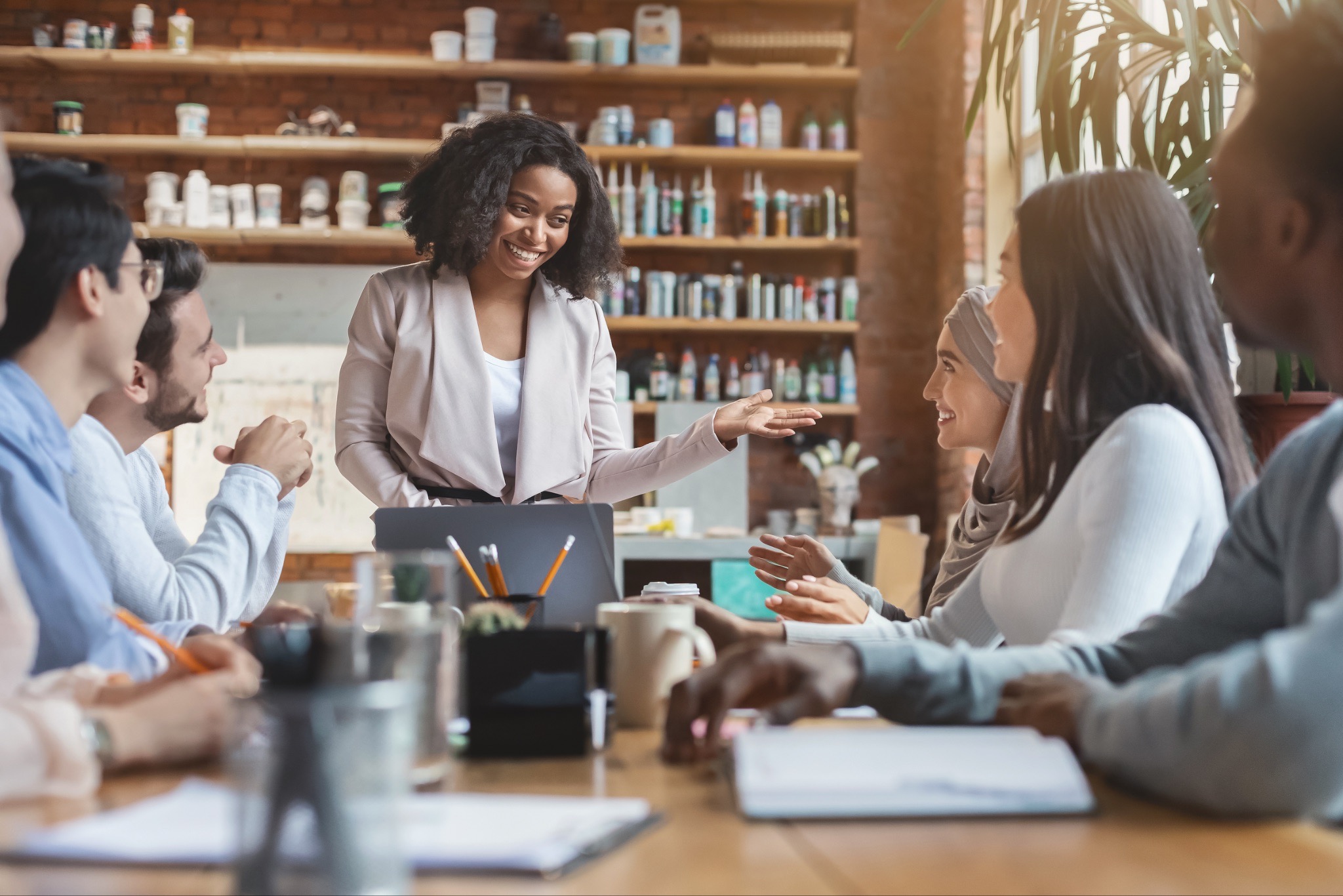 sales team strategy presentation, AI implementation team meeting, revenue team strategic planning, sales leadership discussion, collaborative sales team meeting, AI adoption strategy session, sales team casual office meeting