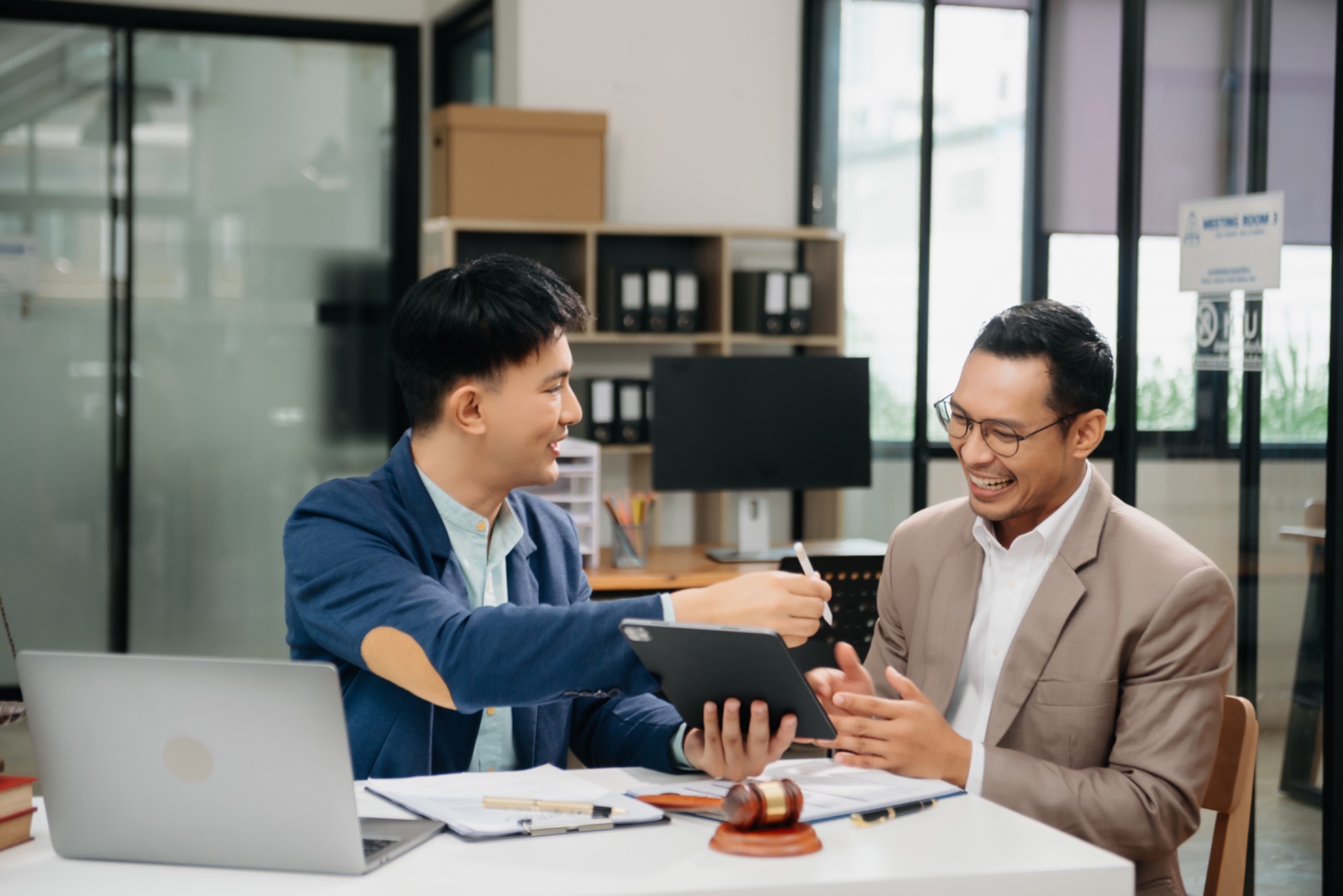 sales team reviewing outreach strategy, B2B sales collaboration desk, outbound program review meeting, sales strategy discussion, colleagues reviewing sales data, sales team planning session, outreach program evaluation
