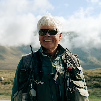Craig Mathews smiling with fishing gear on.