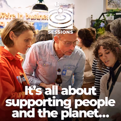 Three people looking at a paper with text that says, "It's all about supporting people and the planet..."