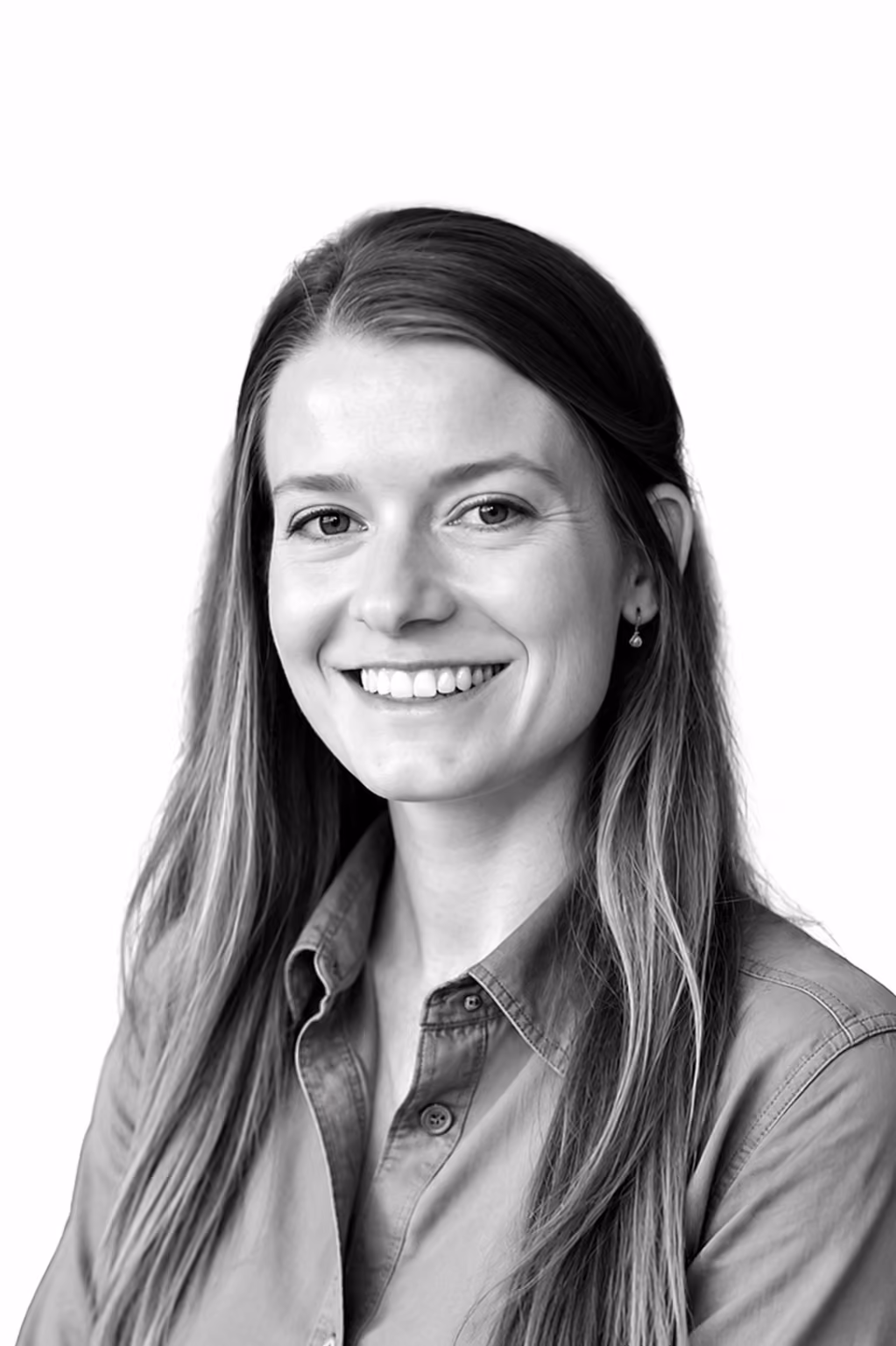 Smiling woman with long hair wearing button-up shirt against a plain white background.