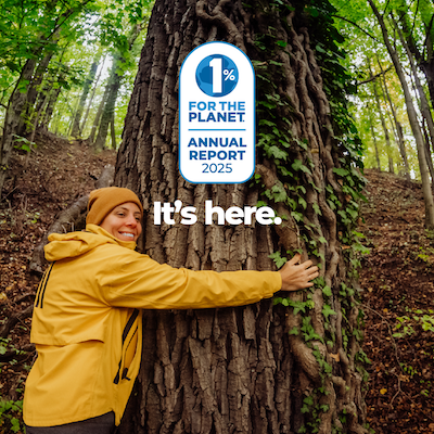 A person in a yellow jacket hugging a tree with text that says, "It's here."