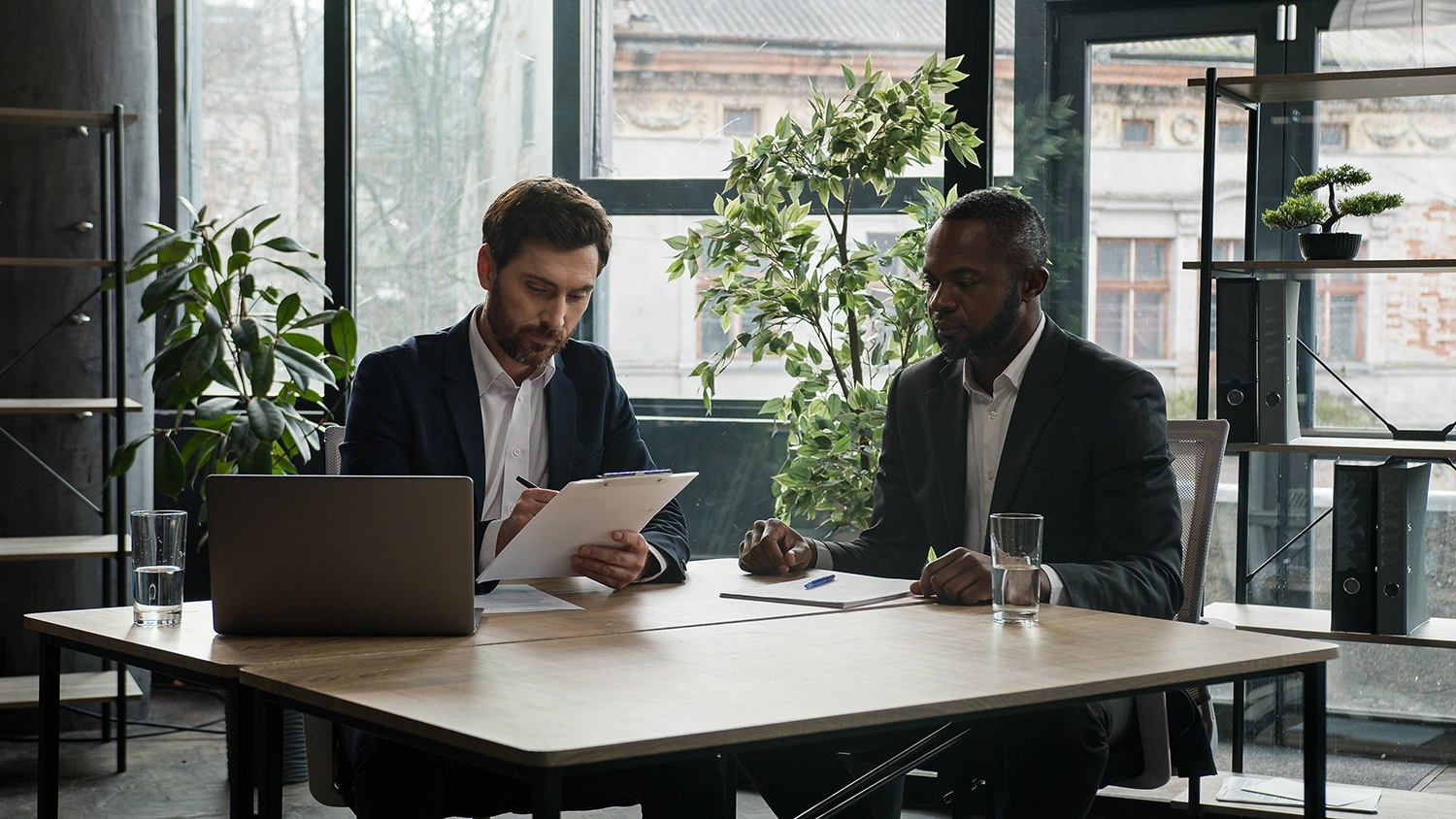 Two businessmen sitting at office desk